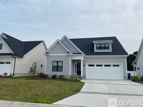 A two-story house with a garage is available for sale.