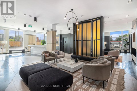 A modern living room with a large sofa set and a glass door.