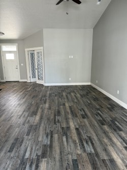 A room with a wooden floor and a ceiling fan.