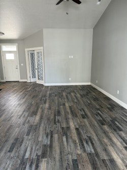 A room with a wooden floor and a ceiling fan.