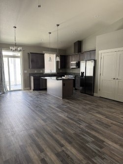A kitchen with a refrigerator, microwave, and oven.