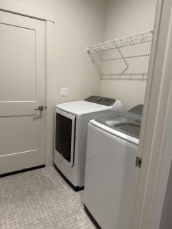 A white door is open to a room with a white fridge and a white microwave.