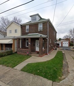 A house with a green roof and a brick facade.