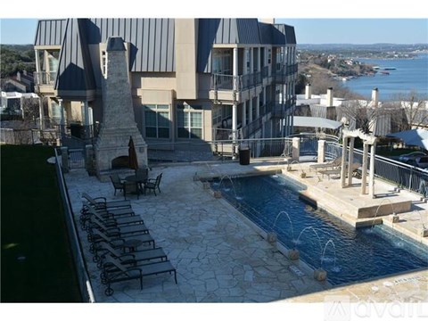 A modern house with a pool and a view of the water.