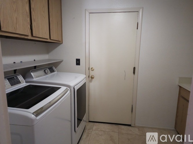 A small kitchen with a washer and dryer.