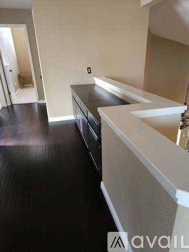 A kitchen with black countertops and white cabinets.