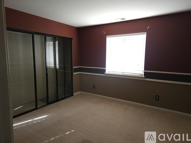 A room with a window and a wall with a window seat.