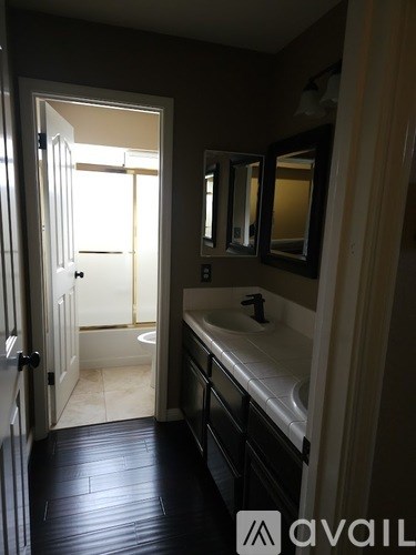 A bathroom with a sink, mirror and a toilet.