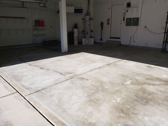 A garage with a concrete floor and white walls.