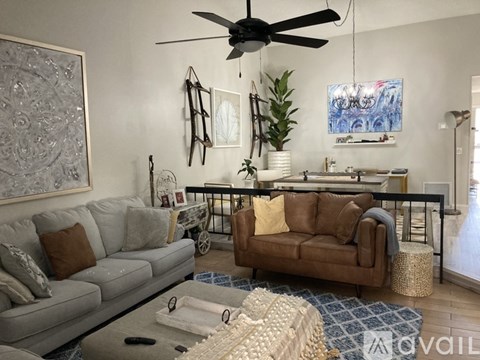 A living room with a grey couch and a brown couch.