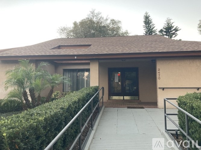 A building with a brown roof and a glass door.