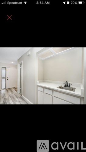 A bathroom with a sink and a mirror.