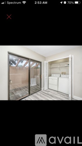 A room with a washing machine and a dryer in it.