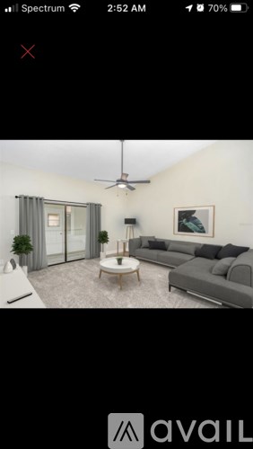 A living room with a grey couch and a coffee table.