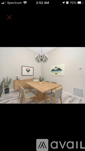 A dining room with a wooden table and chairs.