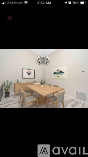 A dining room with a wooden table and chairs.