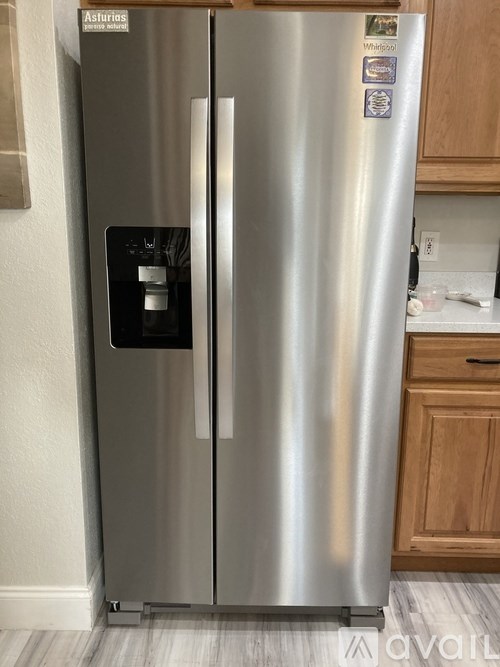 A stainless steel fridge with a water and ice dispenser on the door.