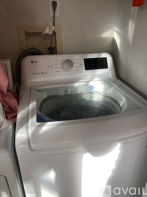 A white LG washing machine with the door open.