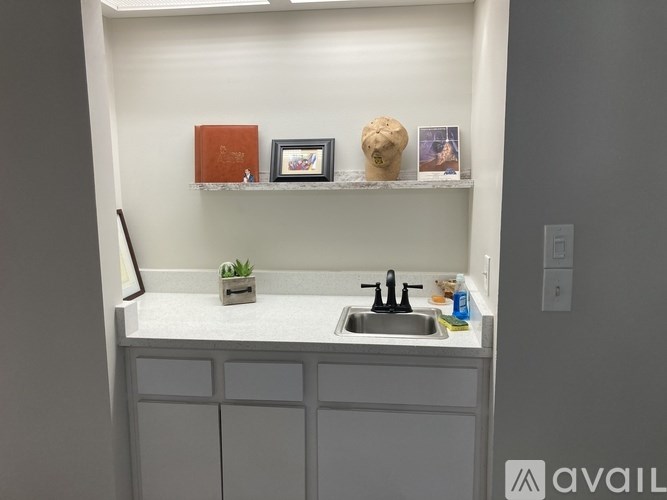A small kitchen with a white counter and a sink.