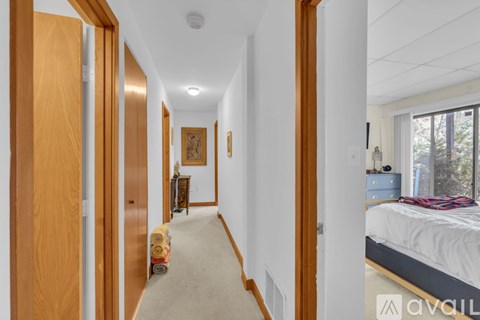 A long hallway with a bedroom at the end.
