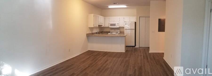 A kitchen area with white cabinets and a countertop.