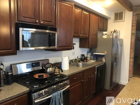 A kitchen with a stove top oven and a microwave above it.