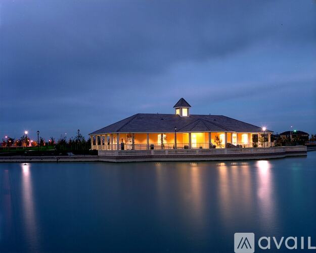 A building with a gazebo-like roof is lit up at night.
