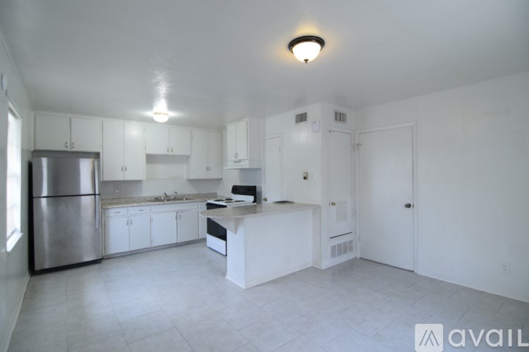 A white bathroom with a toilet, sink, and bathtub.