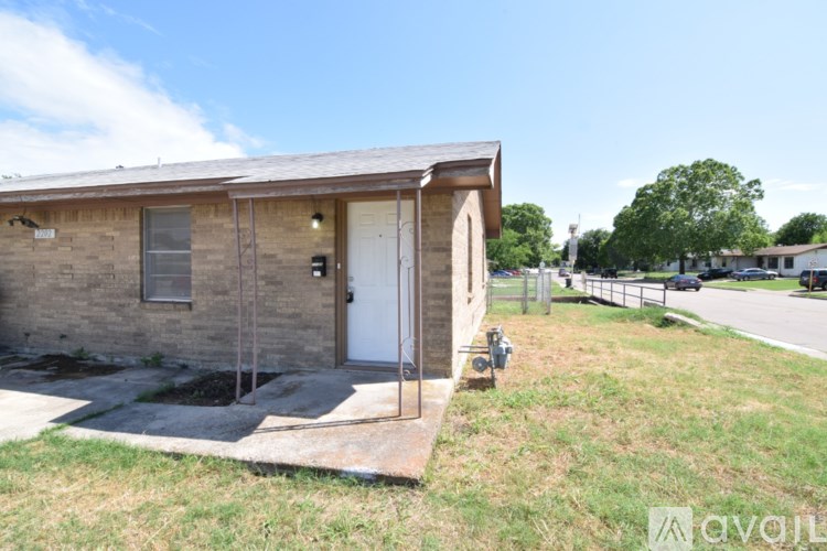 A small house with a white door and a small porch.