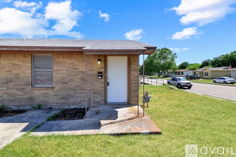 A kitchen with white cabinets and a stainless steel refrigerator.