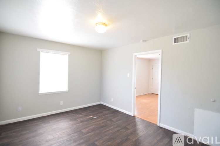 A room with wood flooring and a window.
