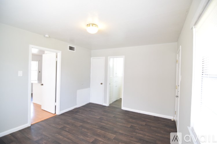A room with wooden floors and white walls.