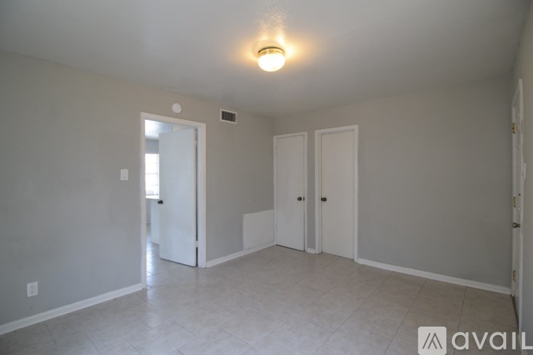 A room with wooden floors and white walls.