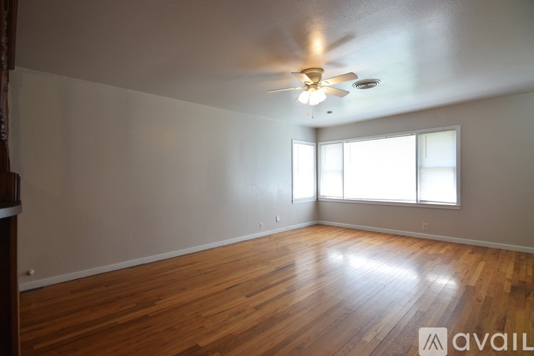 A room with a chandelier and a white wall.