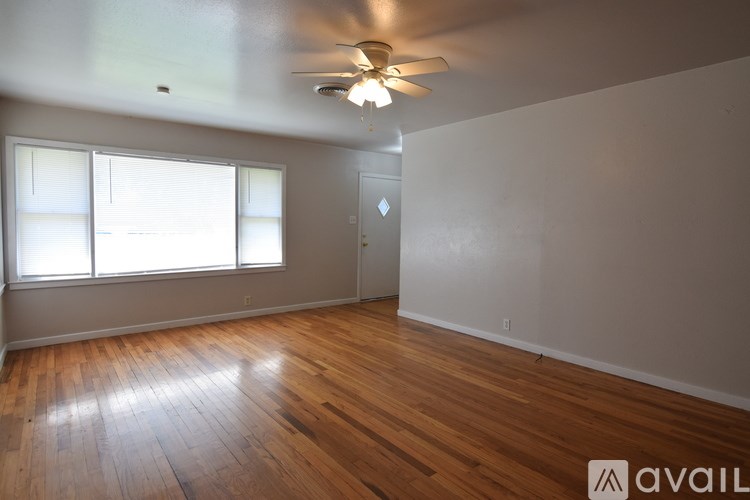 A room with a chandelier and a staircase.