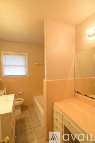 A bathroom with a toilet, sink, and bathtub.