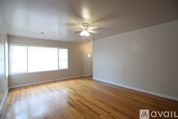 A bathroom with a sink, toilet and mirror.
