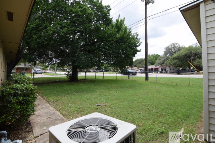 A yard with a fan and a house.