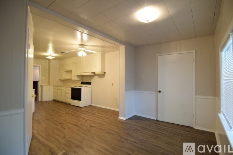 A kitchen area with a stove, oven, and cabinets.