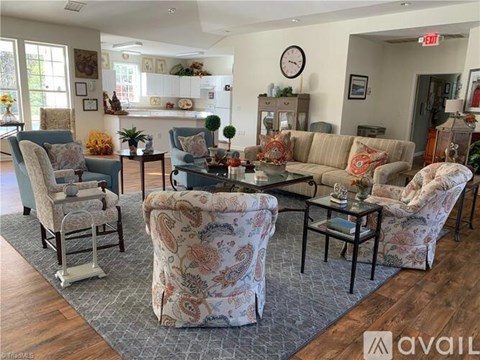 A living room with a patterned sofa and matching chair.