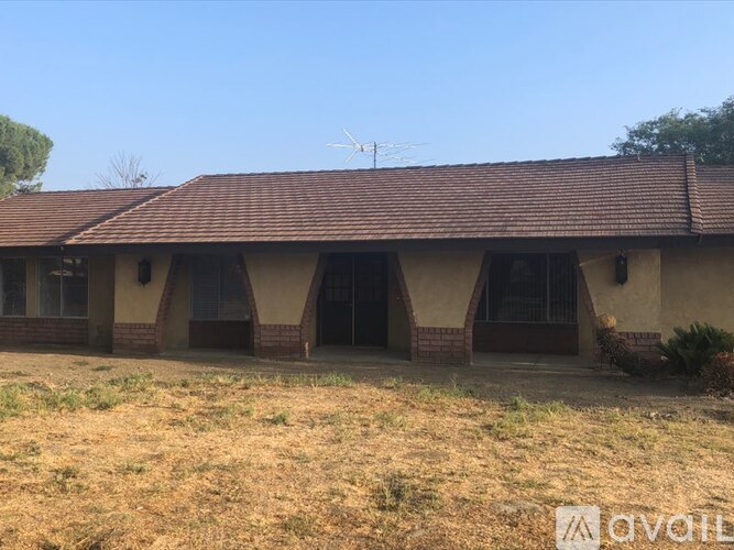 A house with a brown roof and a brown fence.