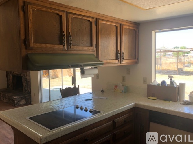 A kitchen with wooden cabinets and a granite countertop.