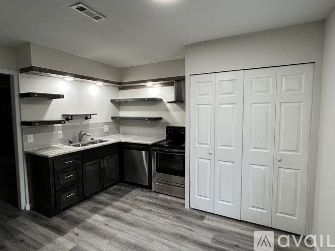 A kitchen with white cabinets and a sink.