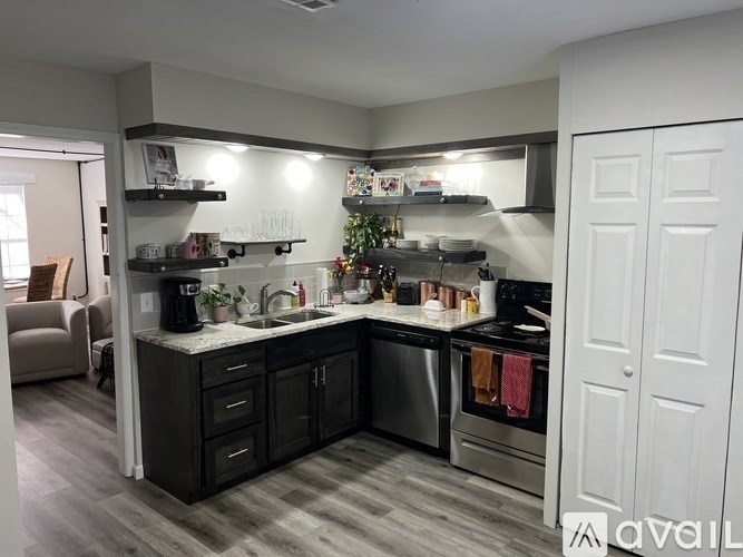 A kitchen with dark wood cabinets and stainless steel appliances.