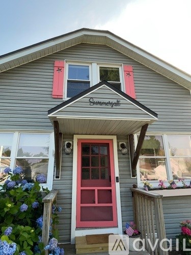 A house with a red door and a sign that says "Havail".