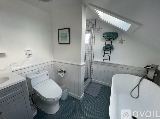 A bathroom with a toilet, sink, and bathtub.