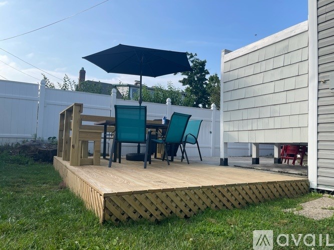 A room with white bunk beds and a ladder.