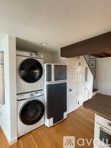 A laundry room with a washer and dryer stacked on top of each other.