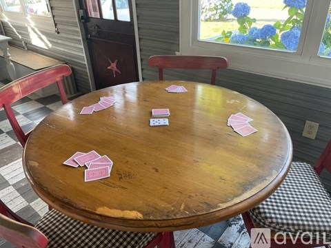 A living room with a blue couch and a rug.