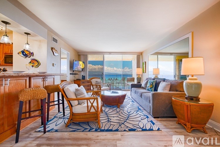 A living room with a view of the ocean.